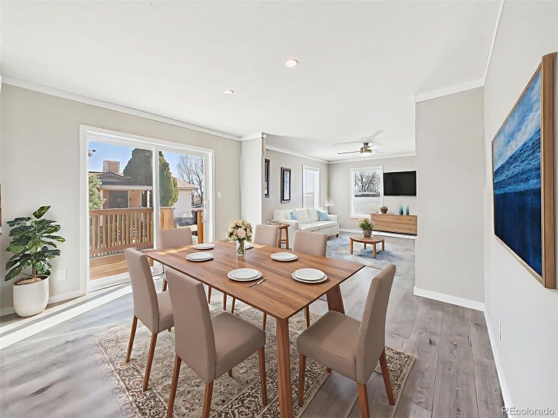 Virtually Staged Dining & Living Areas – Shown here with a transitional style dining set and comfortable living arrangement, this space connects seamlessly to the back deck through large sliding glass doors.