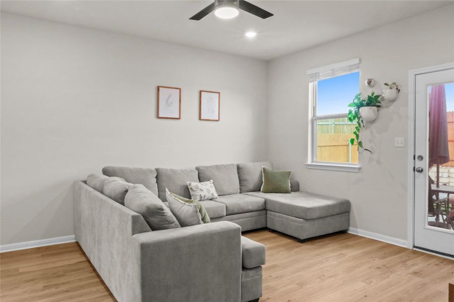 Living area with light wood-type flooring, recessed lighting, and ceiling fan