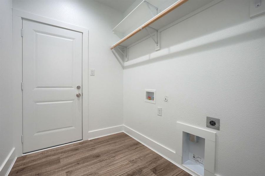 Clothes washing area featuring washer hookup, hardwood / wood-style flooring, gas dryer hookup, and electric dryer hookup