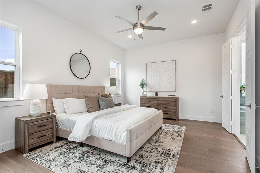 Bedroom with dark hardwood / wood-style floors and ceiling fan