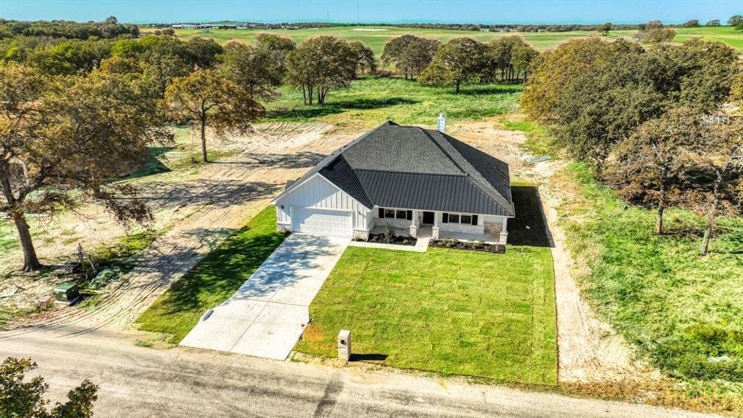 Front exterior of a new home in , Poolville, TX, highlighting curb appeal (Image 20).