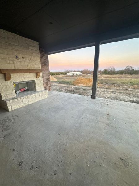View of patio / terrace featuring an outdoor stone fireplace