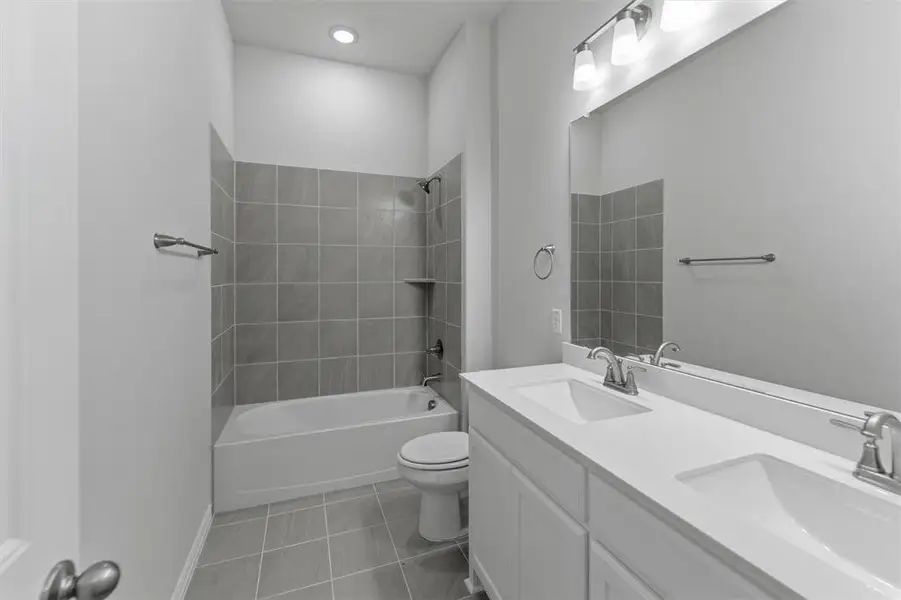 Dual sink vanity with white cabinetry and integrated countertops
