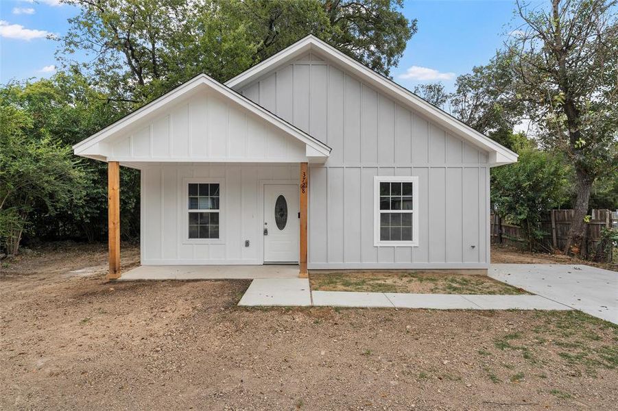 Modern farmhouse featuring board and batten siding and a porch