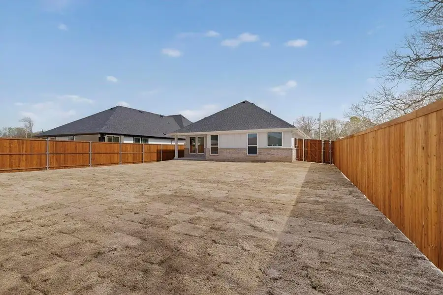 Rear view of property with a patio area, a fenced backyard, and brick siding Rear view of property with a patio area, a fenced backyard, and brick siding