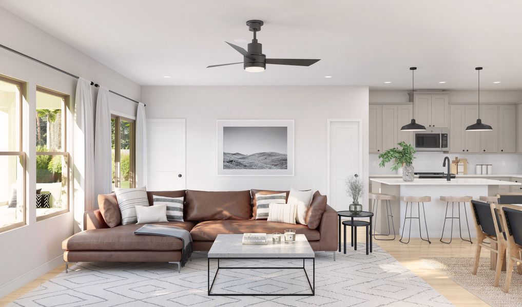 Great room w/ natural light adjacent to the kitchen ideal for entertaining