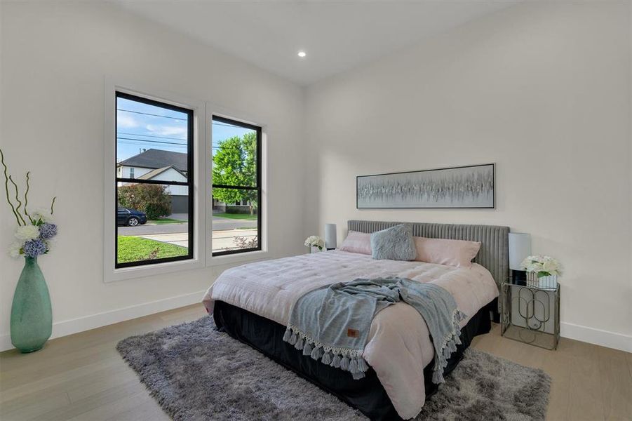 Bedroom with light hardwood / wood-style flooring