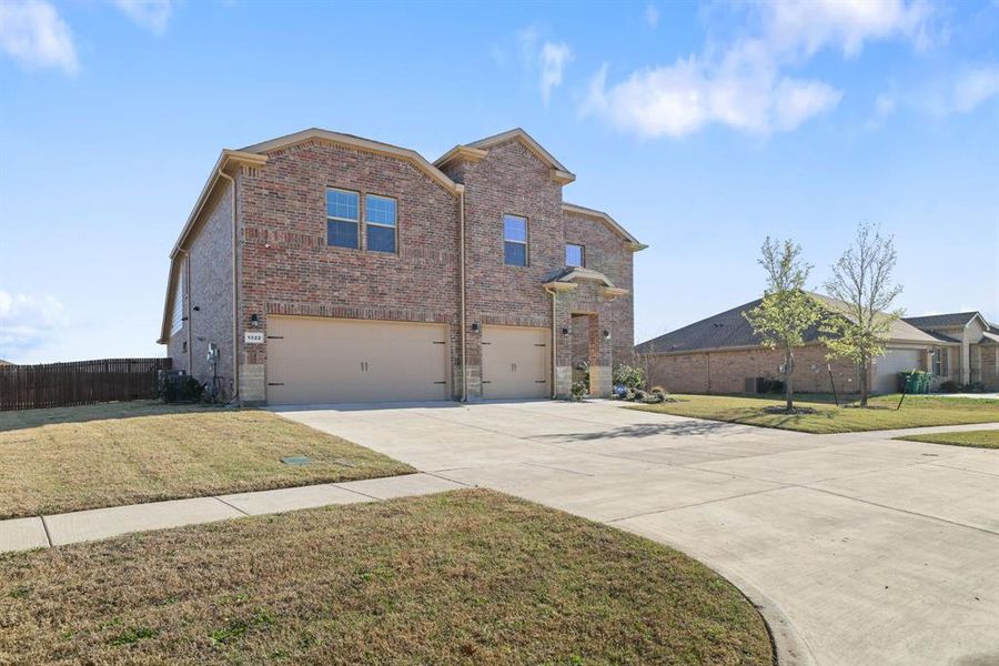 View of front of property with a garage, brick siding, and concrete driveway View of front of property with a garage, brick siding, and concrete driveway