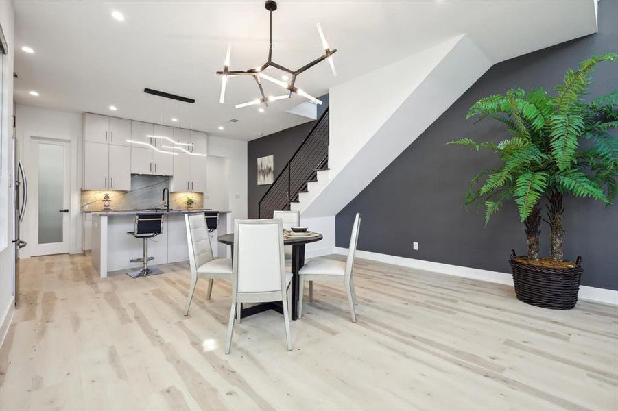 Dining area featuring light hardwood / wood-style floors, sink, and a chandelier