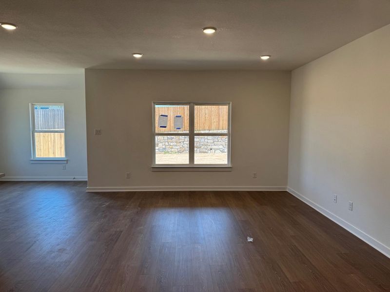 Spare room with dark wood-type flooring and recessed lighting Spare room with dark wood-type flooring and recessed lighting