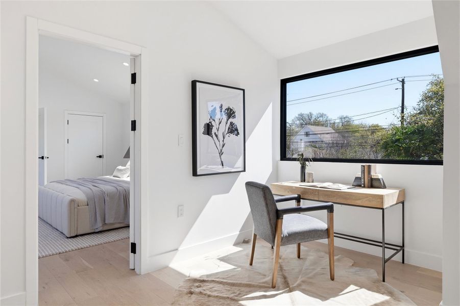 A well-lit, private office space with a window offering views of the neighborhood, adjacent to a bright bedroom. A well-lit, private office space with a window offering views of the neighborhood, adjacent to a bright bedroom.