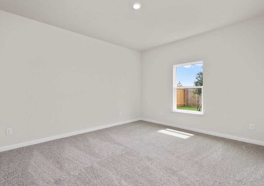 The master bedroom is spacious and has a large window.