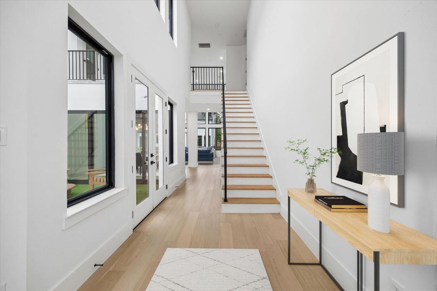 French doors from the 22 foot high formal entry give one of three access points to the central courtyard.
