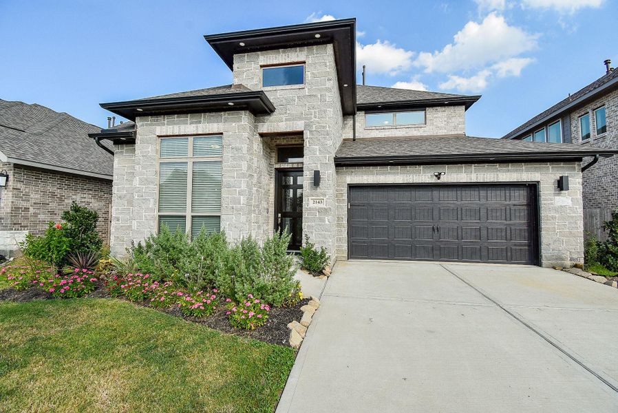 Front exterior of a new home in Stonecreek Estates 50', Richmond, TX, highlighting curb appeal (Image 2).