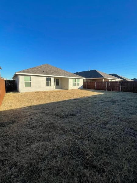 Rear view of property featuring a lawn