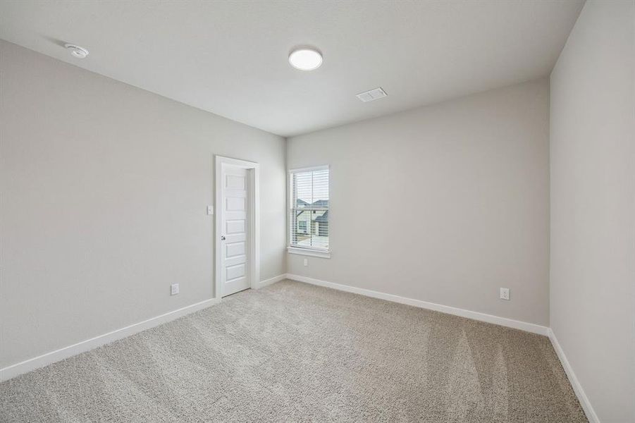 Bedroom in the Stanley II home plan by Trophy Signature Homes – REPRESENTATIVE PHOTO