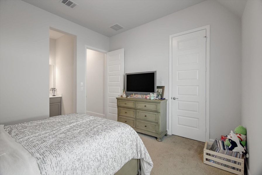 The front secondary bedroom offers a spacious 12' x 13' layout with a walk-in closet and access to a well-appointed Hollywood bathroom shared with the third bedroom.The front secondary bedroom offers a spacious 12' x 13' layout with a walk-in closet and access to a well-appointed Hollywood bathroom shared with the third bedroom.