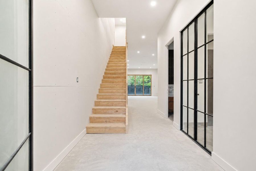 Grand entrance with mono-stringer floating staircase to come - construction stage photo unfinished home.