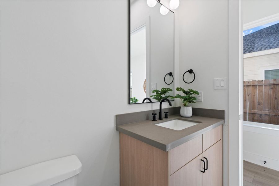 The sleek powder room combines modern finishes with thoughtful design, offering a stylish and functional space for guests. Its clean lines and contemporary touches complement the home’s Scandinavian-inspired aesthetic. A perfect blend of form and function, it adds a polished, inviting detail to the overall home experience. The sleek powder room combines modern finishes with thoughtful design, offering a stylish and functional space for guests. Its clean lines and contemporary touches complement the home’s Scandinavian-inspired aesthetic. A perfect blend of form and function, it adds a polished, inviting detail to the overall home experience.