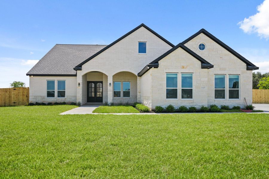 Front exterior of a new home in Blue Jay's Landing, Needville, TX, highlighting curb appeal (Image 1). Front exterior of a new home in Blue Jay's Landing, Needville, TX, highlighting curb appeal (Image 1).