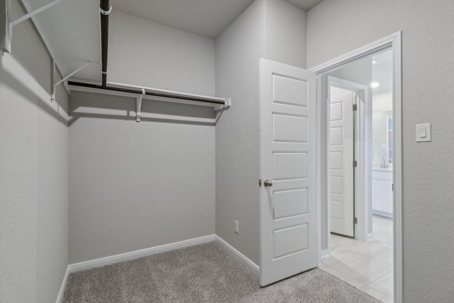 Primary suite walk-in closet in the Allen floorplan at a Meritage Homes community. Primary suite walk-in closet in the Allen floorplan at a Meritage Homes community.