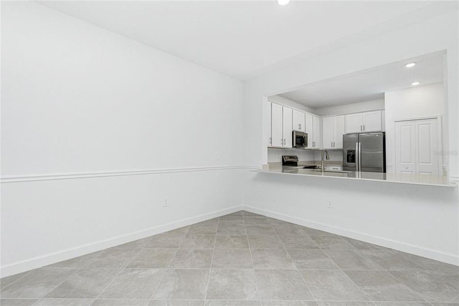 Spacious, unfurnished interior of a new home in Island Lakes at Coco Bay: Villas, Englewood (Image 26).