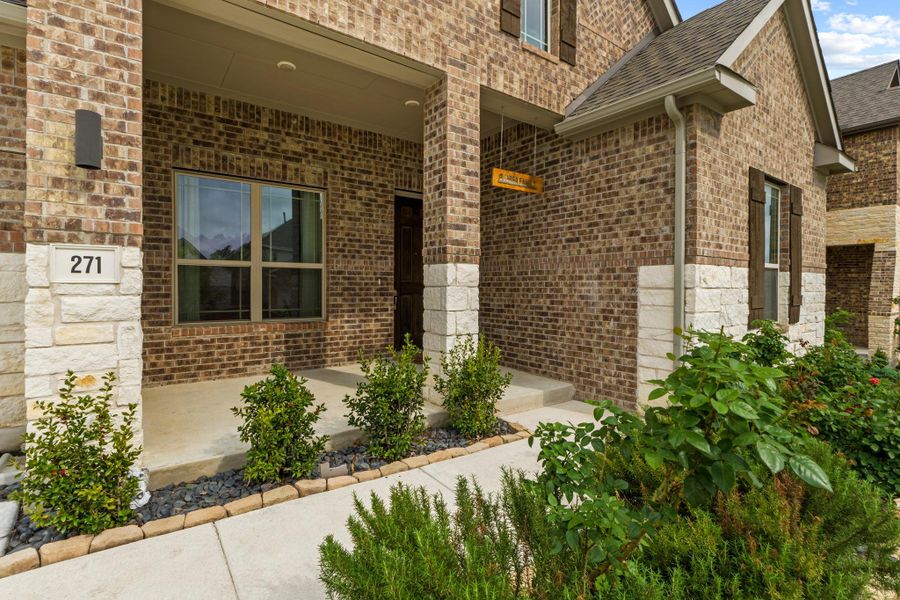A welcoming front porch invites you in to see all this home has to offer.
