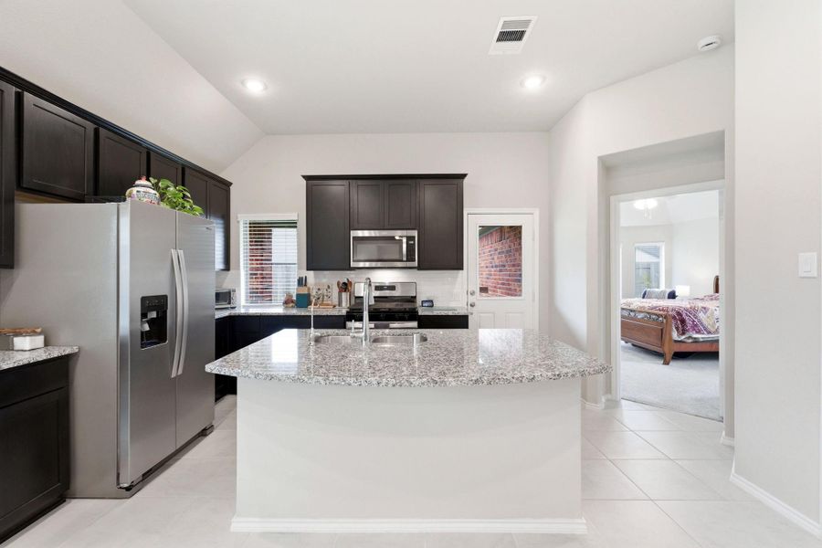 Back door leads to your covered back patio.  Primary bedroom at the back of the home.