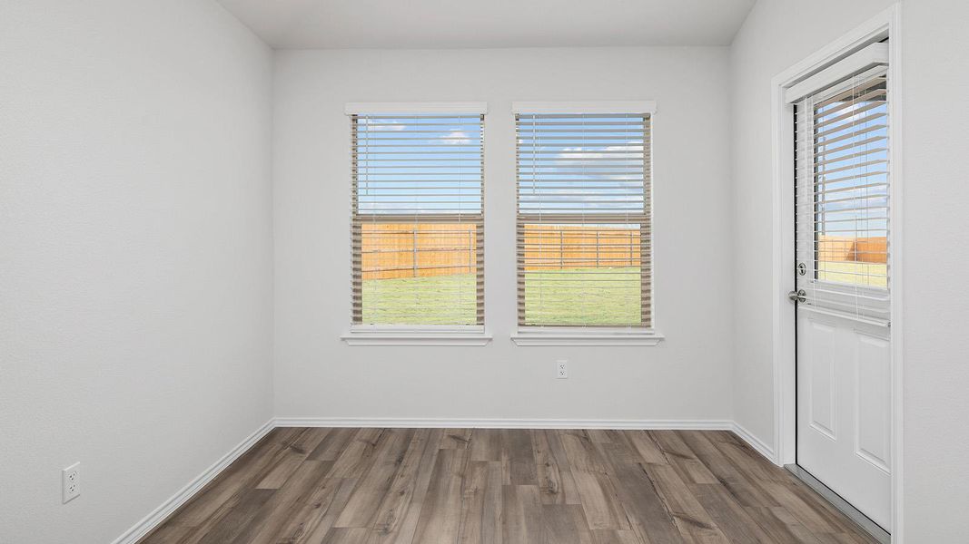 Empty room with dark wood finished floors and baseboards