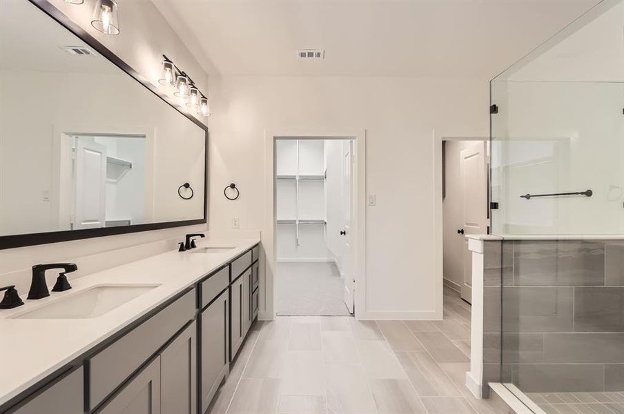 Bathroom featuring vanity and an enclosed shower