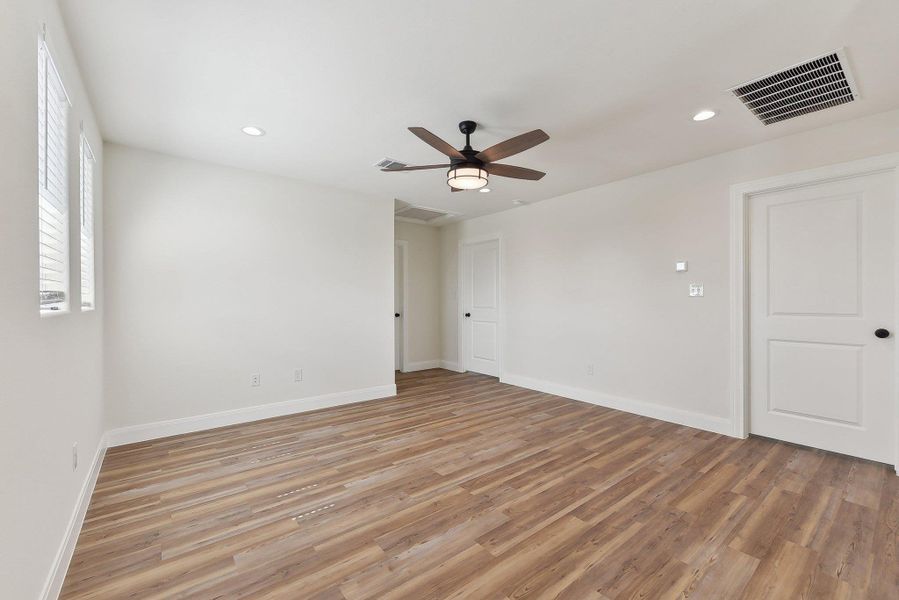 Family room featuring light wood-type flooring, visible vents, a ceiling fan, recessed lighting, and baseboards Family room featuring light wood-type flooring, visible vents, a ceiling fan, recessed lighting, and baseboards