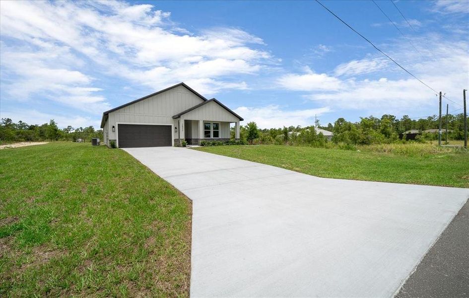 Front exterior of a new home in , Weeki Wachee, FL, highlighting curb appeal (Image 28). Front exterior of a new home in , Weeki Wachee, FL, highlighting curb appeal (Image 28).