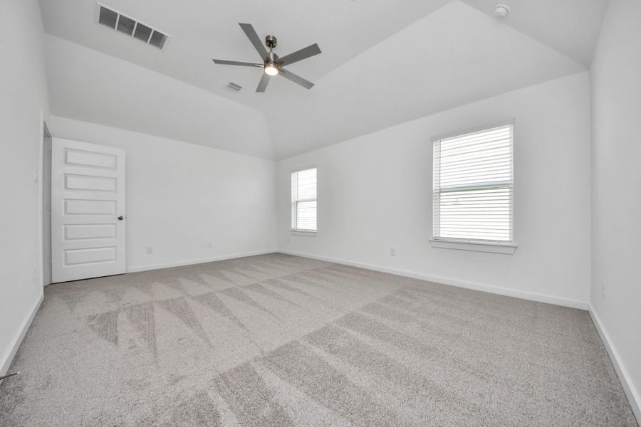 Another perspective unveils a comprehensive view of the serenity and comfort this primary suite offers. Sample photo of completed home with similar floor plan. Actual colors and selections may vary.
