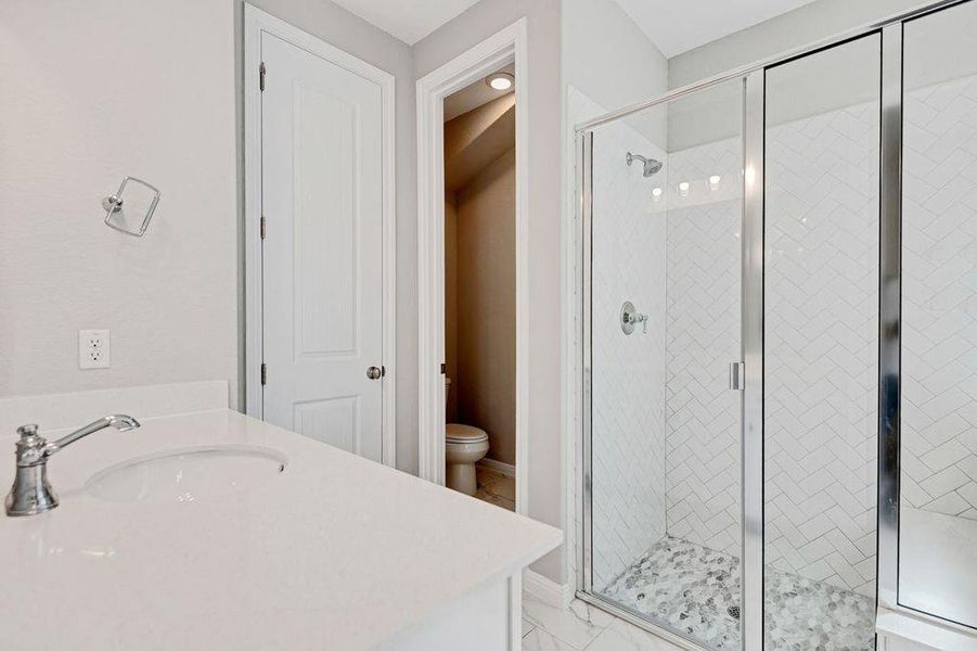 Full bath featuring a shower stall and vanity Full bath featuring a shower stall and vanity