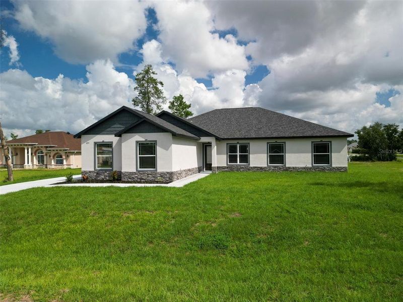 Front exterior of a new home in , Ocala, FL, highlighting curb appeal (Image 2). Front exterior of a new home in , Ocala, FL, highlighting curb appeal (Image 2).