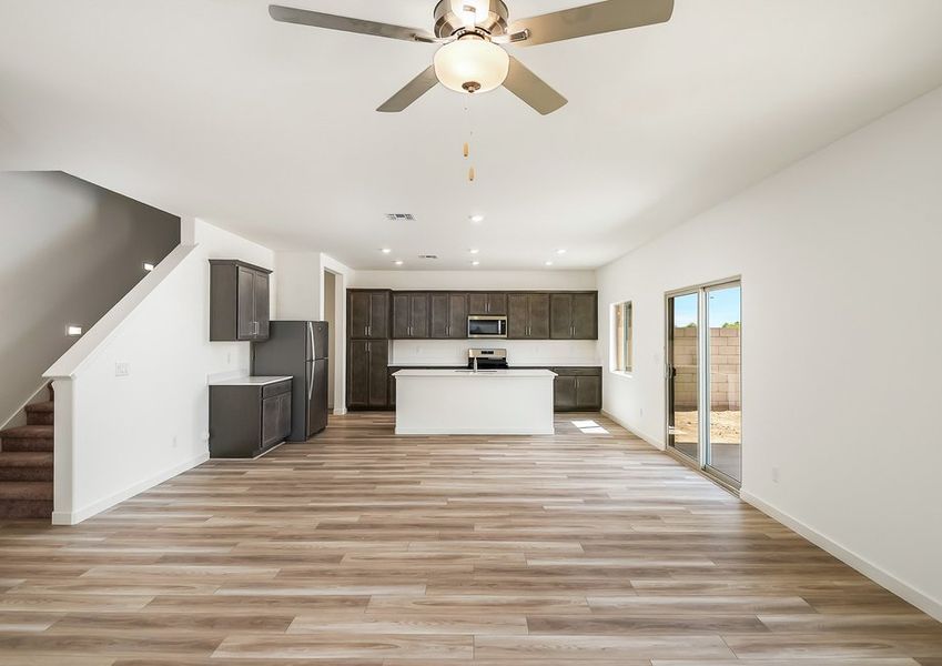 Open-concept family room with staircase and kitchen view in Wellton floor plan