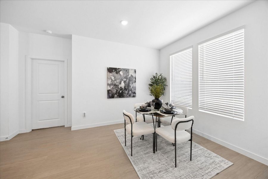 This casual dining area keeps everyday meals easy, with natural light, LVP flooring and a comfortable spot to linger long after the plates are cleared.