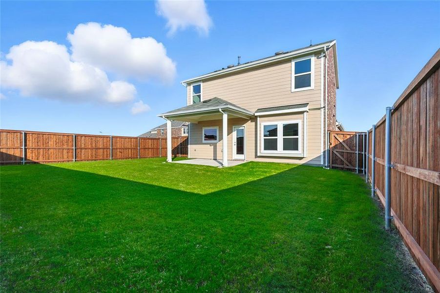 Rear view of house with a patio and a fenced backyard Rear view of house with a patio and a fenced backyard