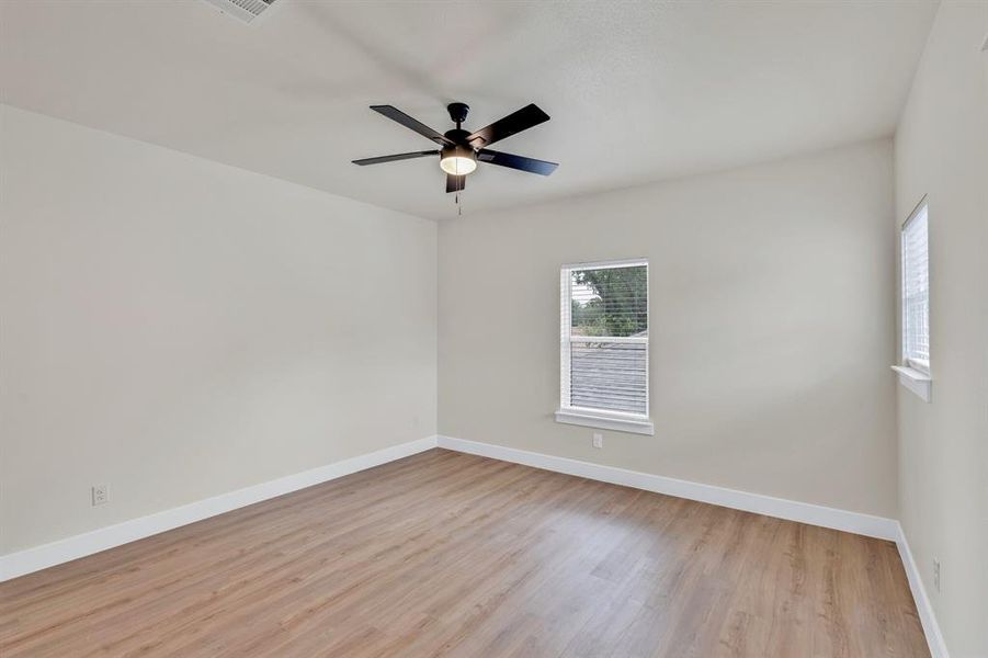 Spare room with ceiling fan and light hardwood / wood-style floors