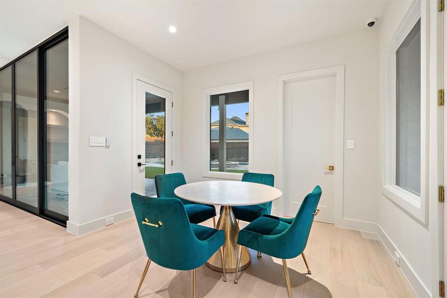 The breakfast area is nestled in an alcove with several windows, a great way to start you day with serene backyard and pool views!