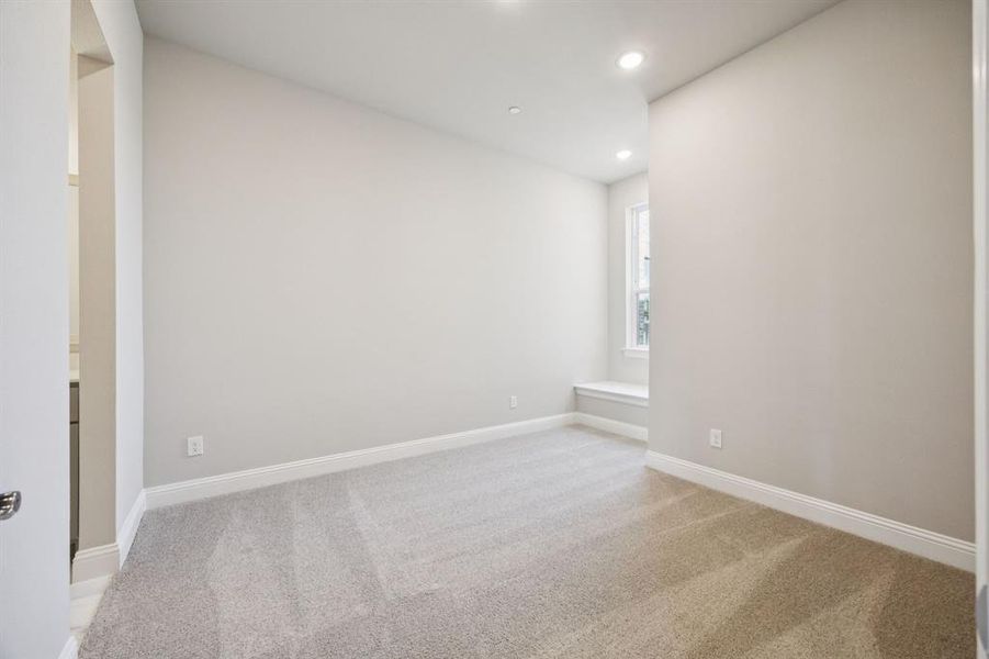Secondary bedroom with window seat.