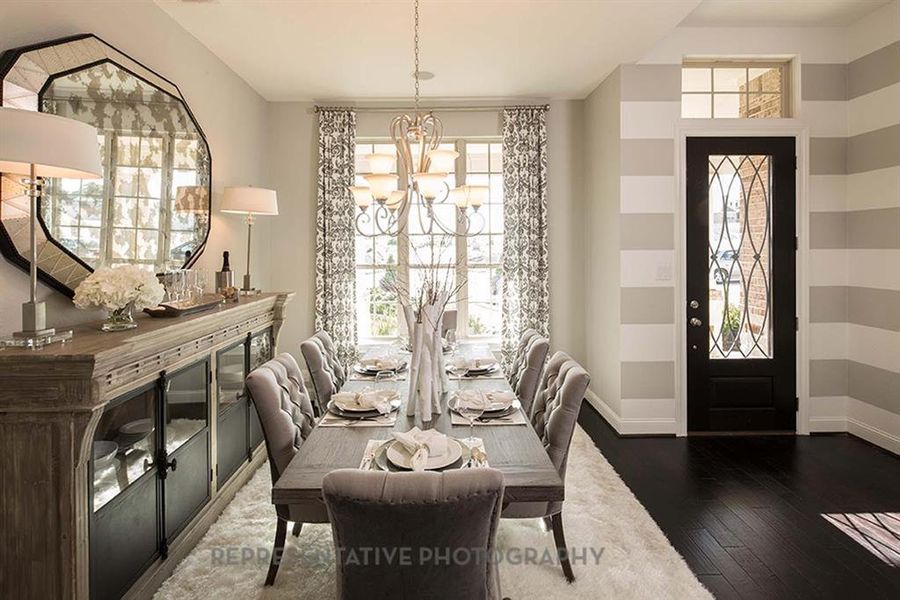 Dining room with dark wood-style flooring and a chandelier Dining room with dark wood-style flooring and a chandelier