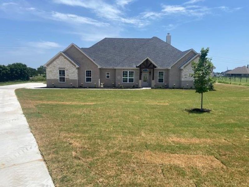 Front exterior of a new home in , Azle, TX, highlighting curb appeal (Image 1). Front exterior of a new home in , Azle, TX, highlighting curb appeal (Image 1).