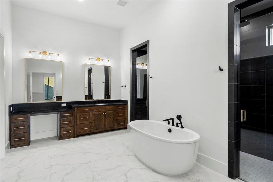 Full bath with vanity, a freestanding bath, light marble finish flooring, and a stall shower Full bath with vanity, a freestanding bath, light marble finish flooring, and a stall shower