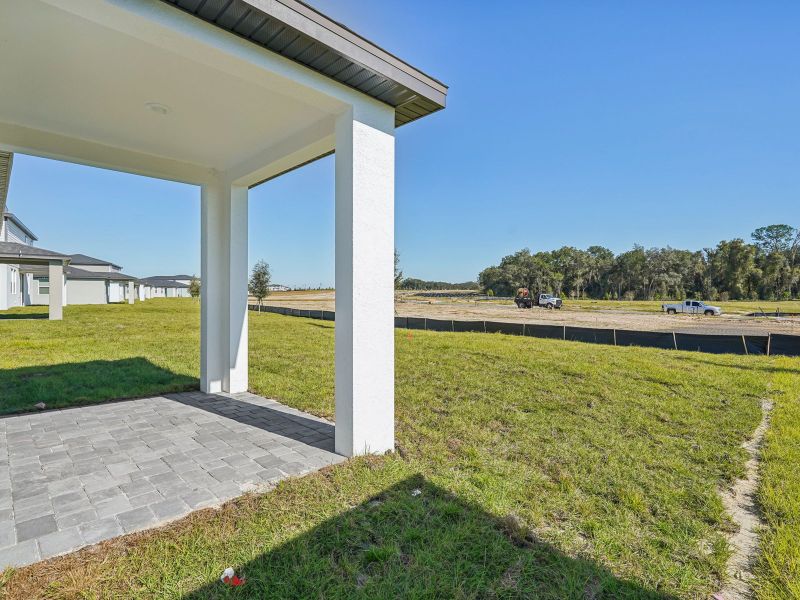 Exterior details and patio area of a home in The Reserve at Hammock Oaks - Signature Series, Lady Lake (Image 3).