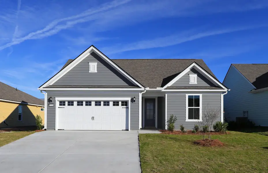 Front exterior of a new home in Midpoint at New Riverside, Bluffton, SC, highlighting curb appeal (Image 18). Front exterior of a new home in Midpoint at New Riverside, Bluffton, SC, highlighting curb appeal (Image 18).