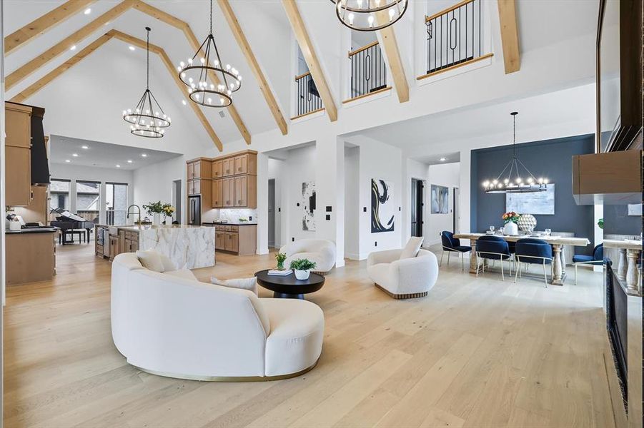 Living room featuring built in shelves & cabinets, a high end fireplace, and light hardwood flooring Living room featuring built in shelves & cabinets, a high end fireplace, and light hardwood flooring