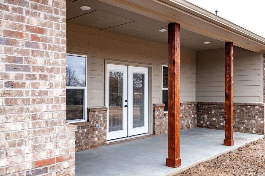 Property entrance featuring french doors and a patio area