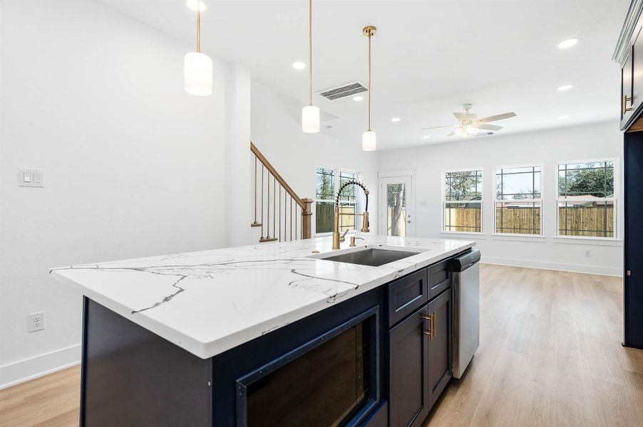 Perspective view highlighting the quartz countertops and seamless flow into the bright living space.
