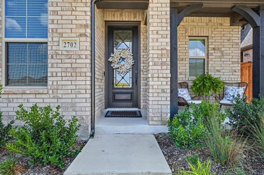 Entrance to property featuring brick siding